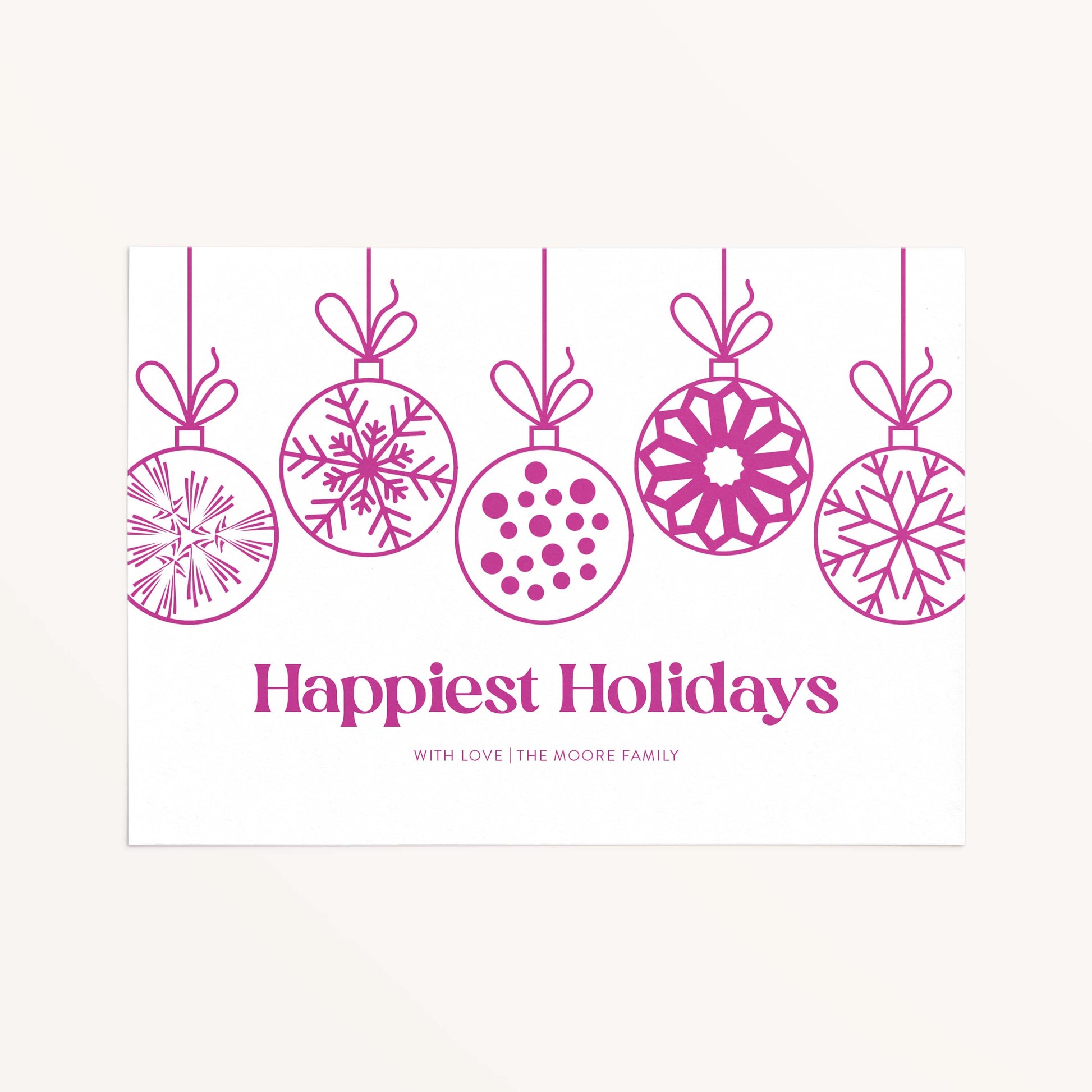 Personalized holiday card with modern hanging ornaments and Happiest Holidays message in magenta.