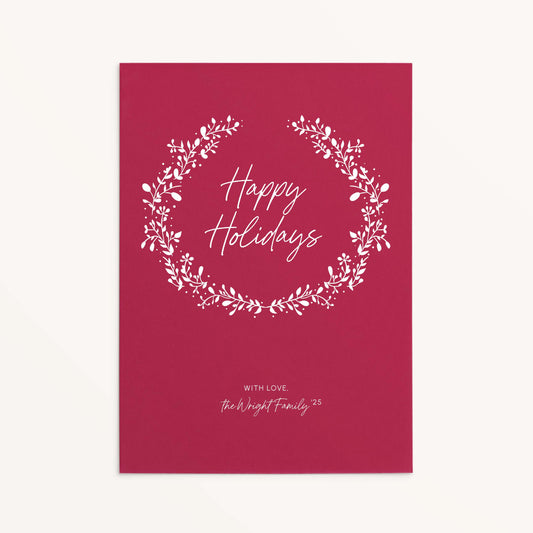 Personalized red holiday card with white botanical wreath and Happy Holidays text.