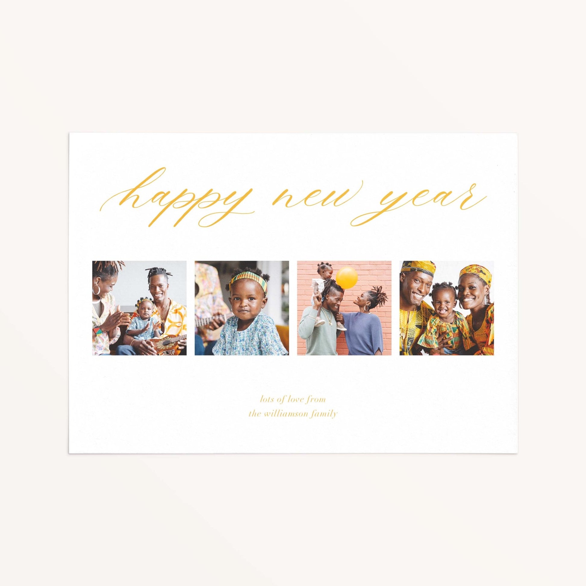 Four Photo Holiday Card with Happy New Year greeting and four family photos in clean modern layout.