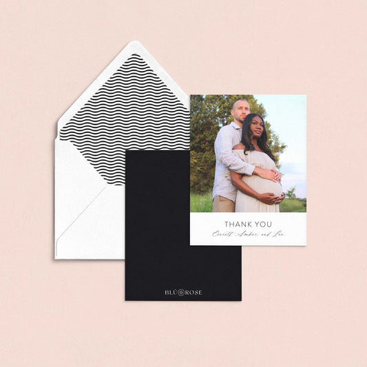 a couple posing for a photograph, with a "Thank You" card placed below the photo.