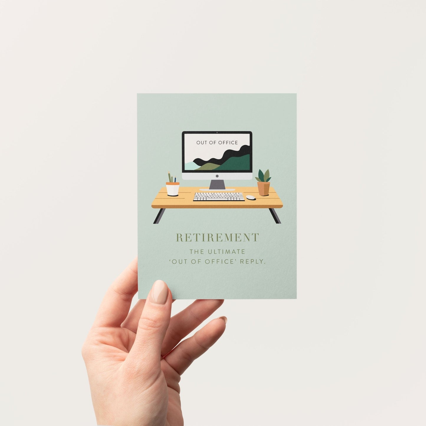 Person holding retirement greeting card in front of a neutral background.