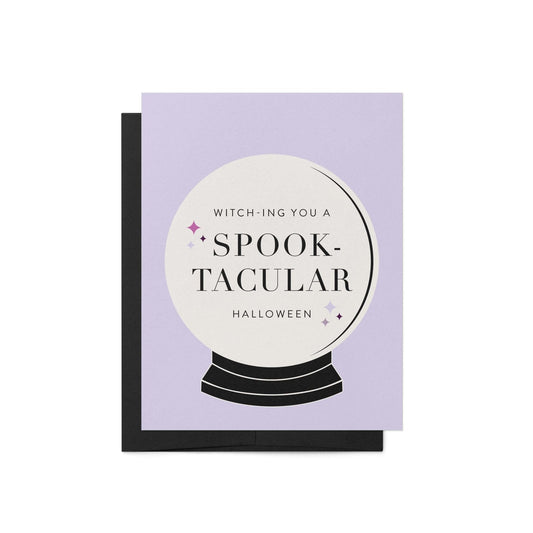 Spooktacular Halloween greeting card with witchy crystal ball design on lavender background paired with black envelope.