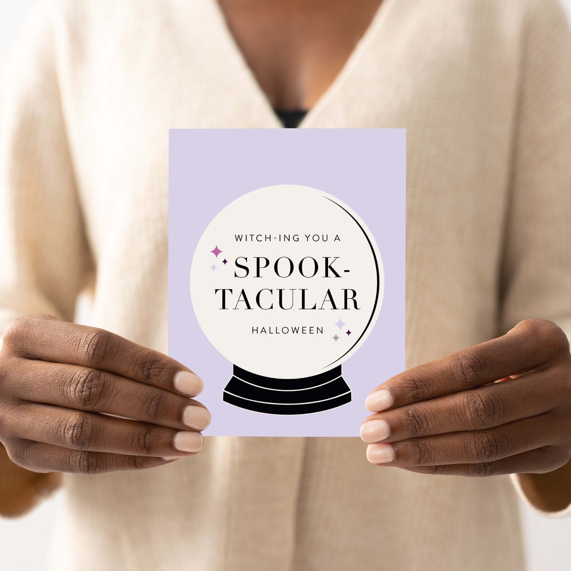 Close-up of chic Halloween greeting card with witchy crystal ball design.