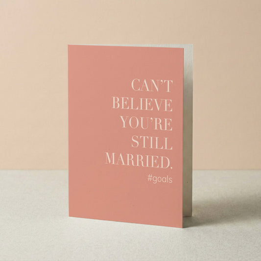 Pink card with white text on a beige background