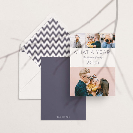 What a Year holiday card shown with matching envelopes in a modern flat lay with neutral background.