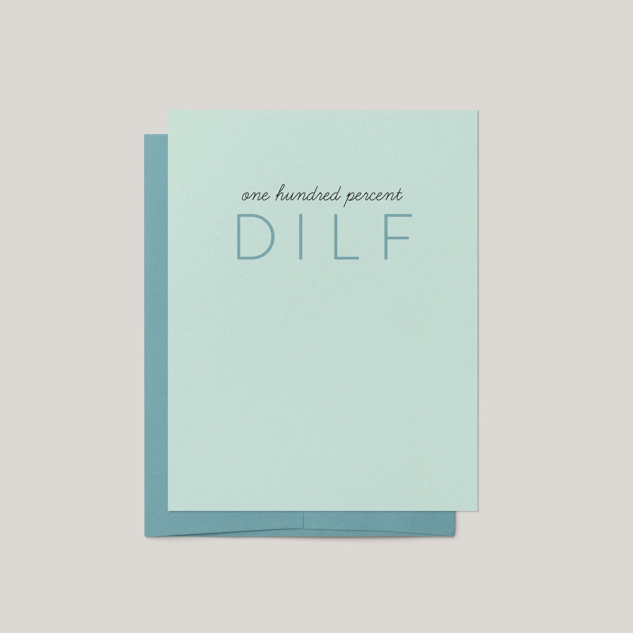 100% DILF funny Father's Day greeting card by Blú Rose, pale mint card with tonal blue lettering, shown with matching blue envelope