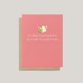 A pink greeting card with a kraft envelope, featuring a small avocado and toast illustration above the text, 'So glad you found the avocado to your toast.' on a light gray background.