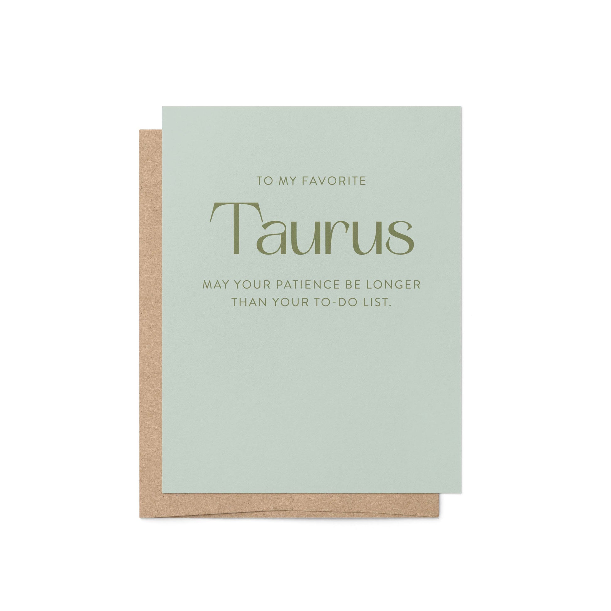 Taurus astrology greeting card in sage green with kraft envelope showing witty birthday message in bold serif typography