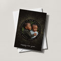 New Year Sparkle photo card in black with a gold starburst wreath framing a baby photo