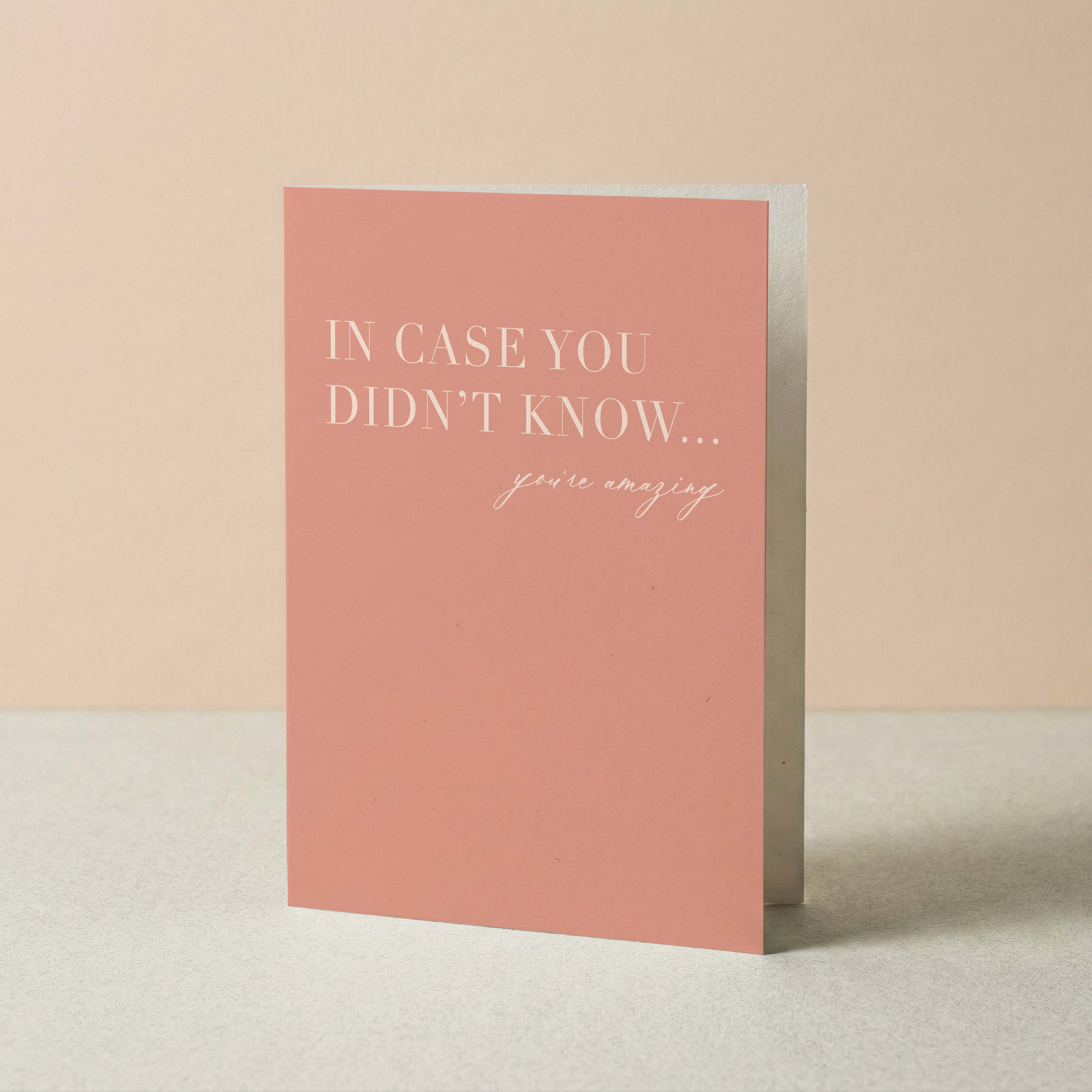 A vertical greeting card in a dusty pink color with white text that reads 'IN CASE YOU DIDN'T KNOW... you're amazing