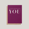 A magenta greeting card with white text reading 'I'M KINDA OBSESSED WITH YOU' layered over a kraft paper envelope, shown on a light gray background.