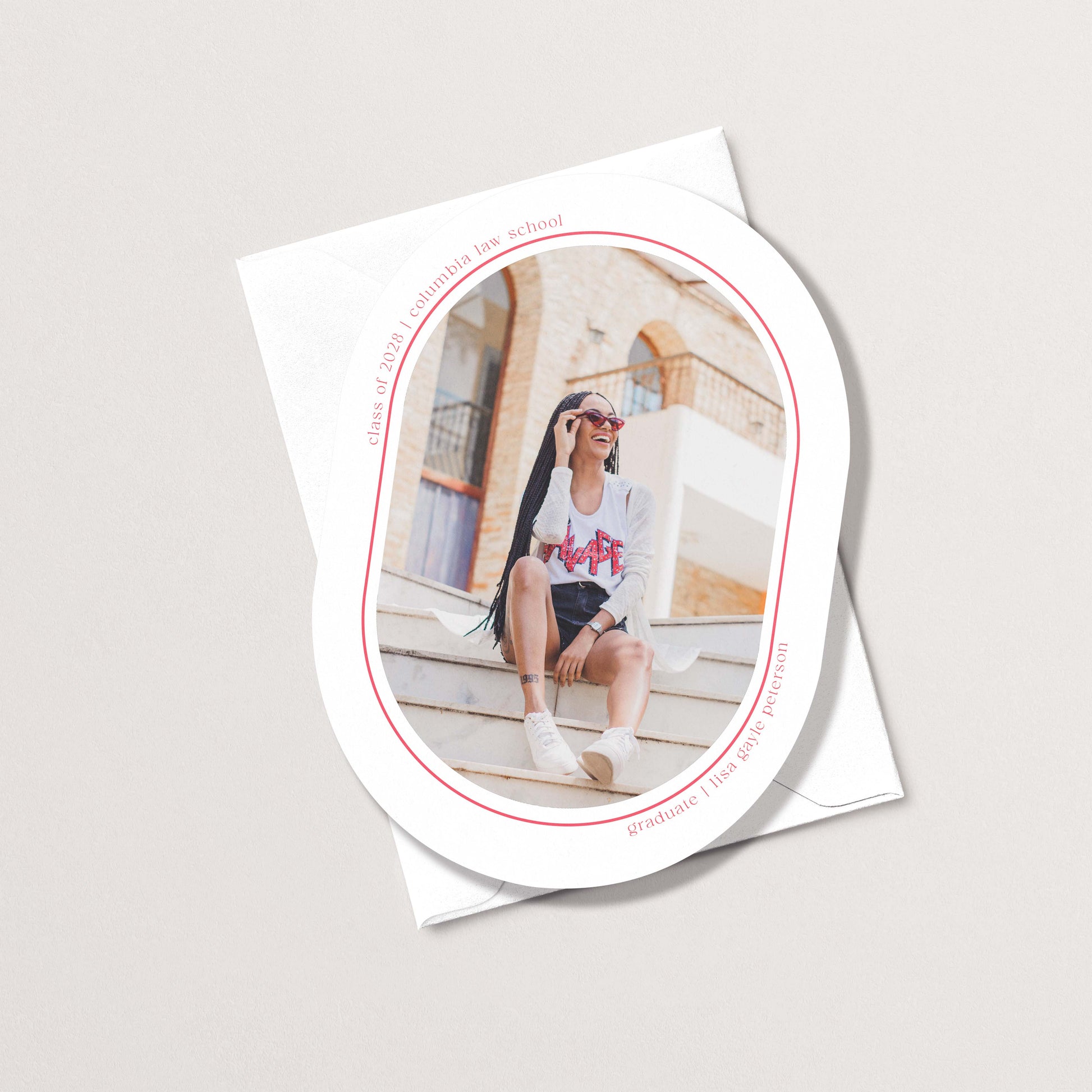 Minimal Geo graduation announcement card with oval photo cutout showing grad sitting on steps, with personalized name and school details