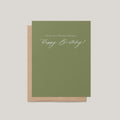 A Few Days Late belated birthday greeting card by Blú Rose, sage green card with cream script Happy Birthday text, shown with kraft envelope