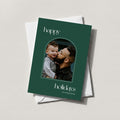 Arch Photo card in forest green with an arch-shaped family photo and happy holidays in script