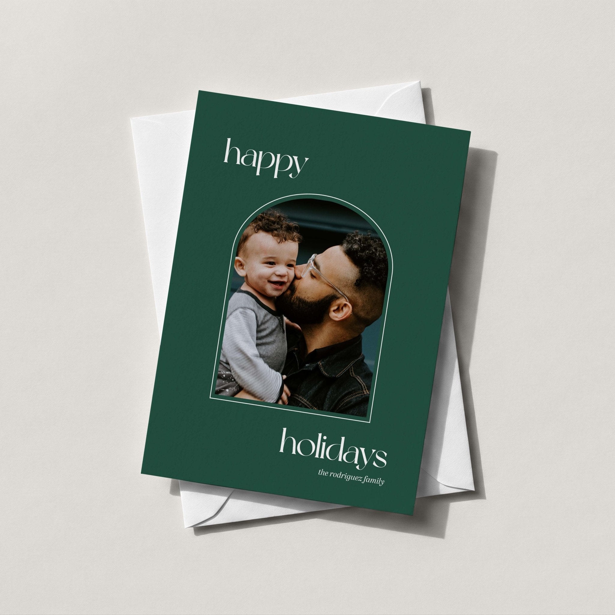 Arch Photo card in forest green with an arch-shaped family photo and happy holidays in script