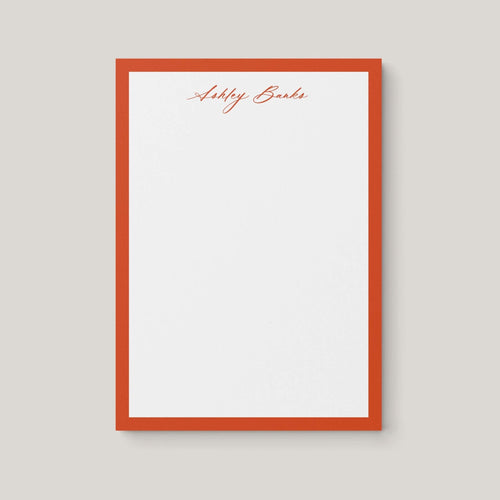 Ashley Border personalized notepad by Blú Rose, white notepad with a rust border and the name 'Ashley Banks' in rust script