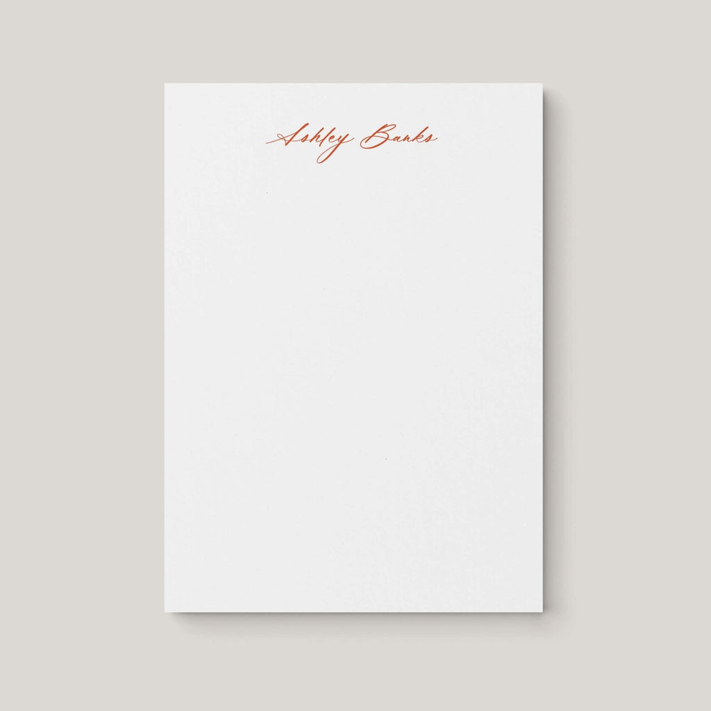Ashley personalized notepad by Blú Rose, white notepad with the name 'Ashley Banks' in rust cursive script