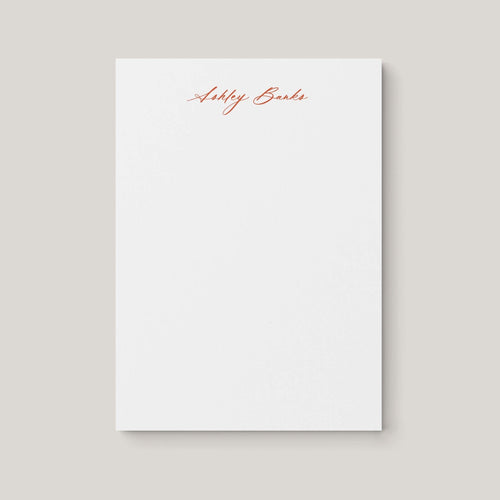 Ashley personalized notepad by Blú Rose, white notepad with the name 'Ashley Banks' in rust cursive script