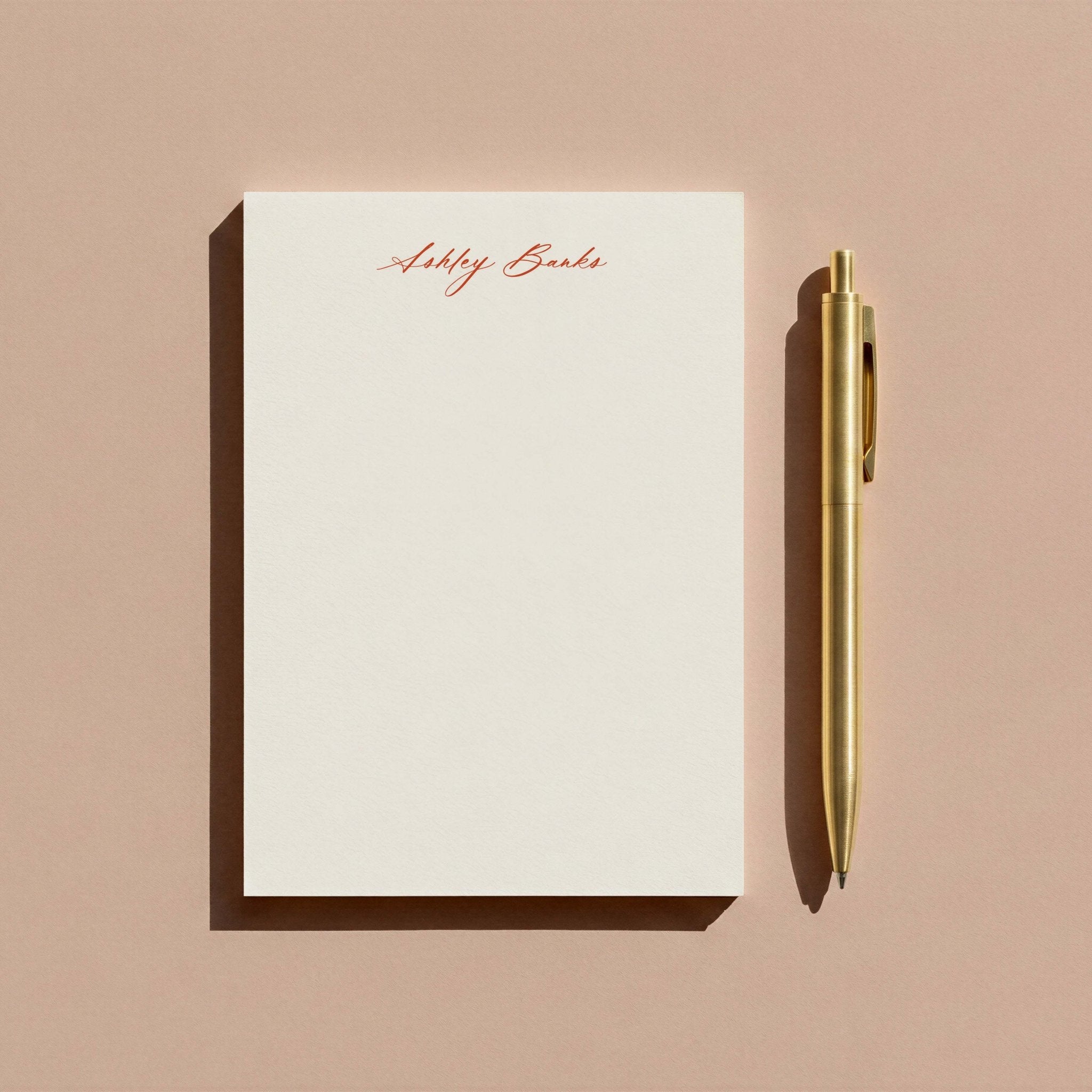 Ashley personalized notepad by Blú Rose, script-name notepad photographed with a gold pen on a mauve background