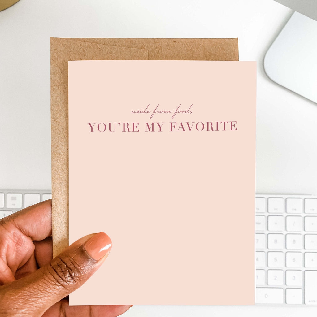 Aside From Food You're My Favorite card by Blú Rose held in hand over a white desk with keyboard and kraft envelope