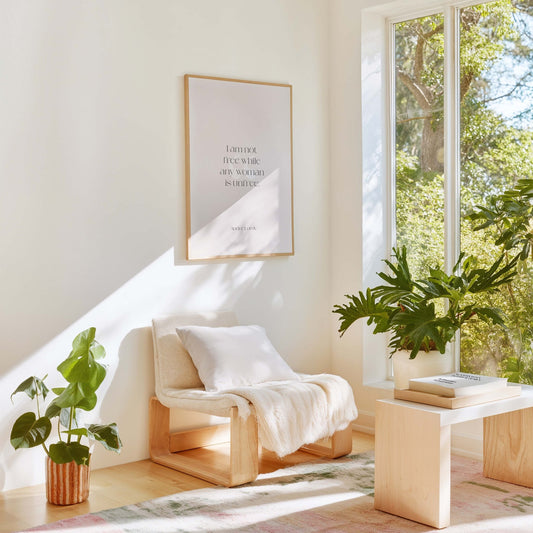 Audre Lorde feminist quote poster styled in bright modern living room with plants and chair