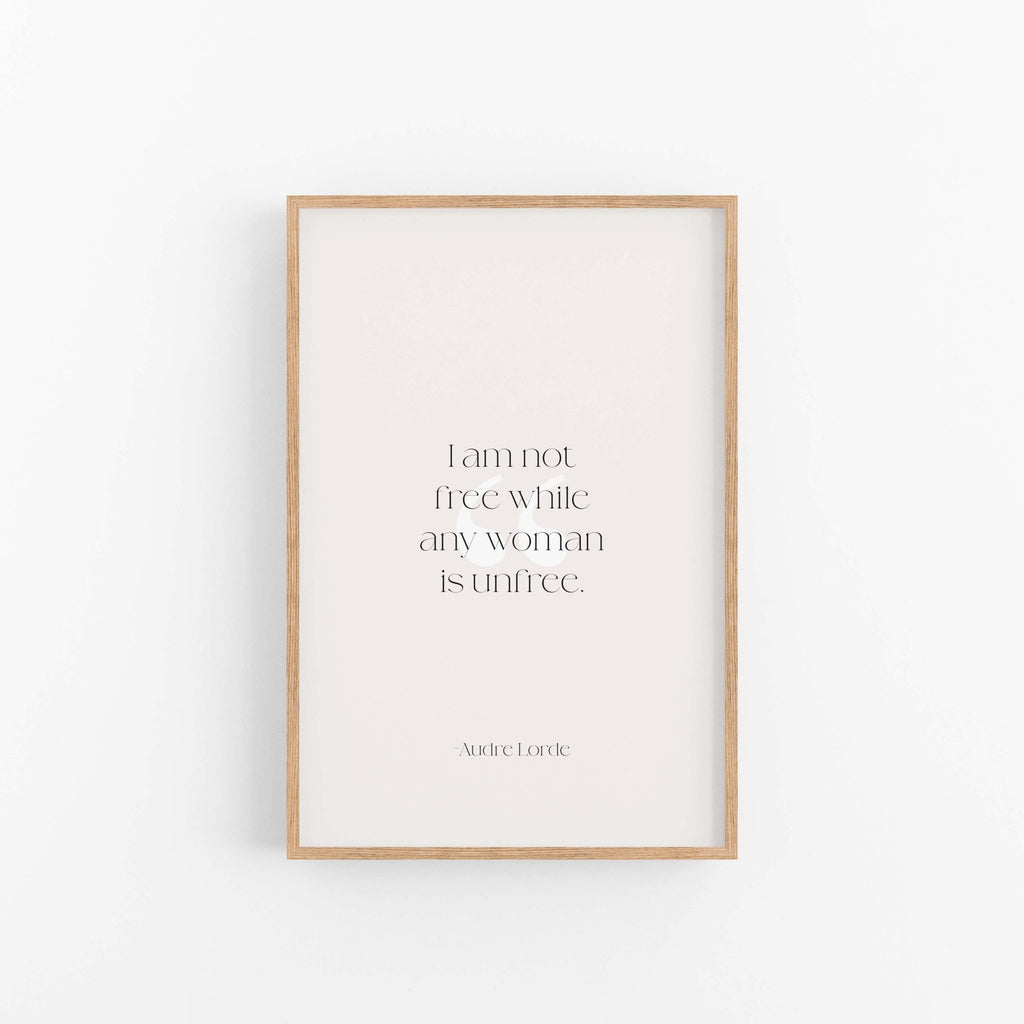 Light wood framed Audre Lorde feminist quote print centered on clean neutral background