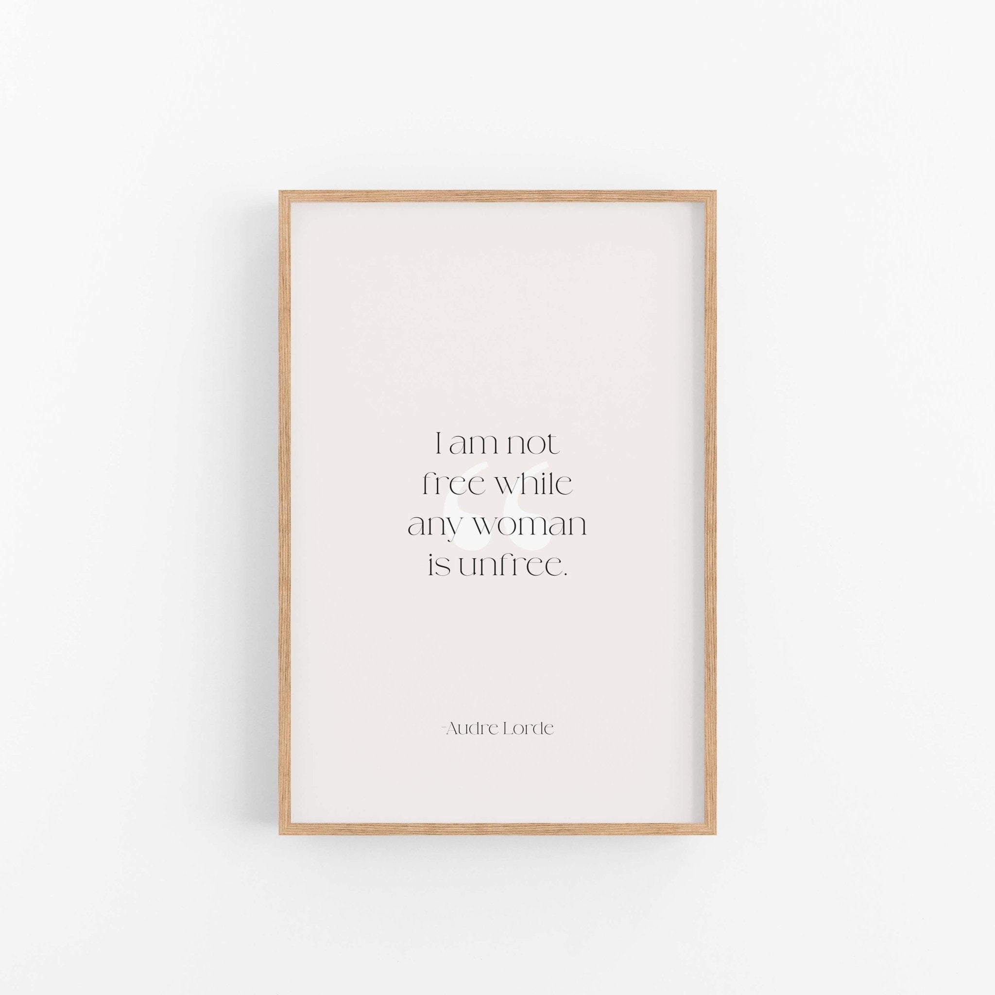 Light wood framed Audre Lorde feminist quote print centered on clean neutral background