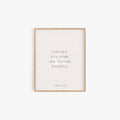 Minimalist Audre Lorde quote art print in light wood frame on neutral wall