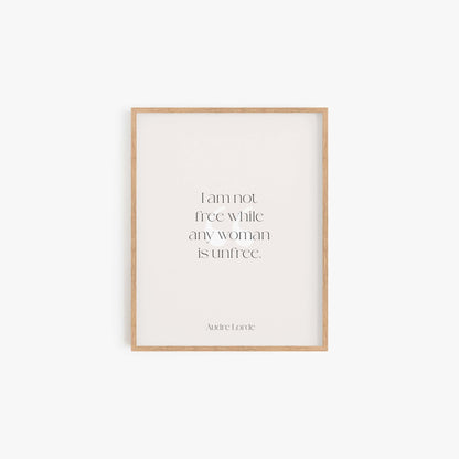 Minimalist Audre Lorde quote art print in light wood frame on neutral wall