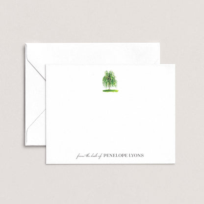 a white envelope with a green tree illustration on the front, and a personalized note on the back.