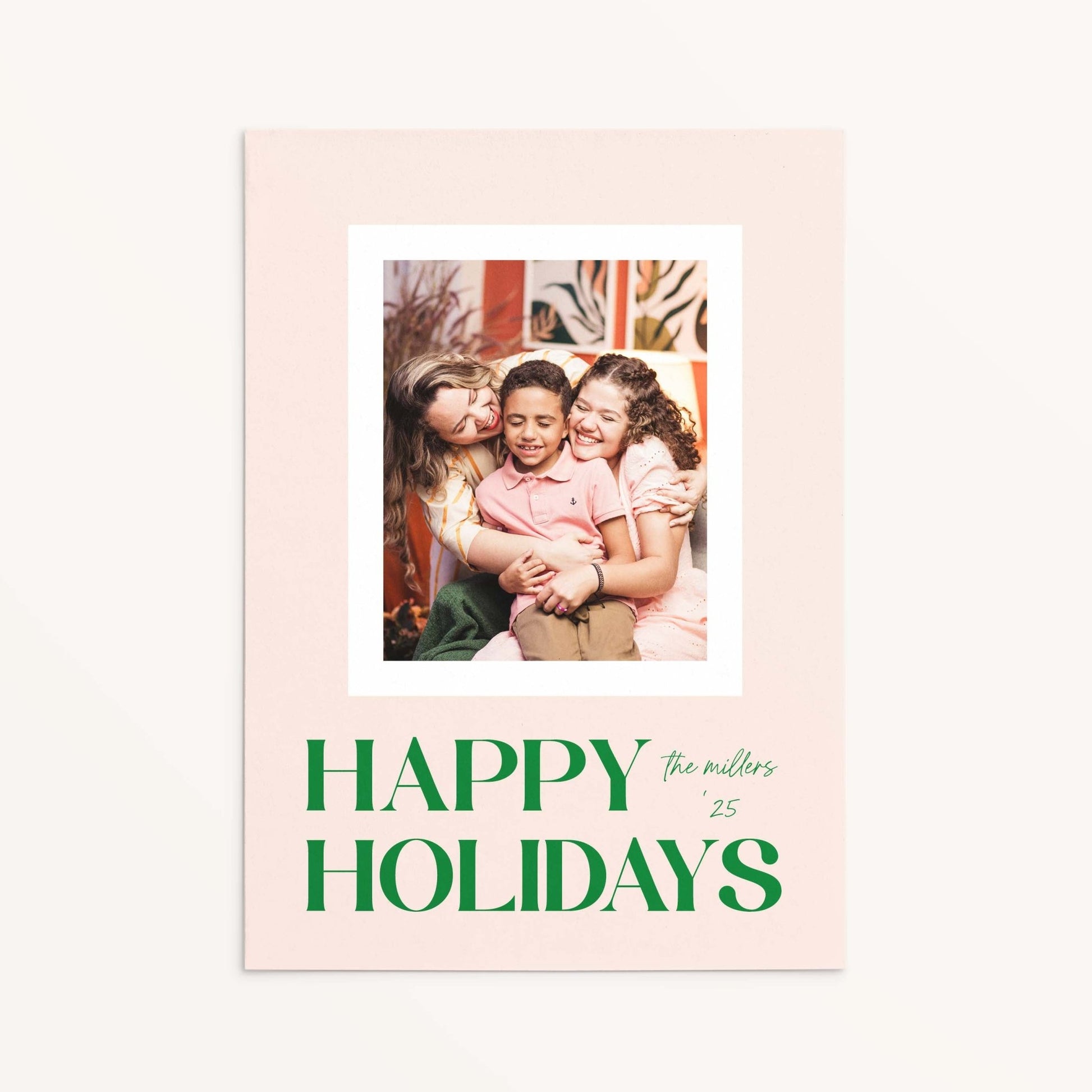 Blush Frame Happy Holidays photo card featuring family photo with bold green serif lettering.