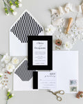 Bold Border wedding invitation suite by Blú Rose, invitation and RSVP card with a bold black border and script names, styled with geometric-lined envelopes, ribbon, and a wax seal