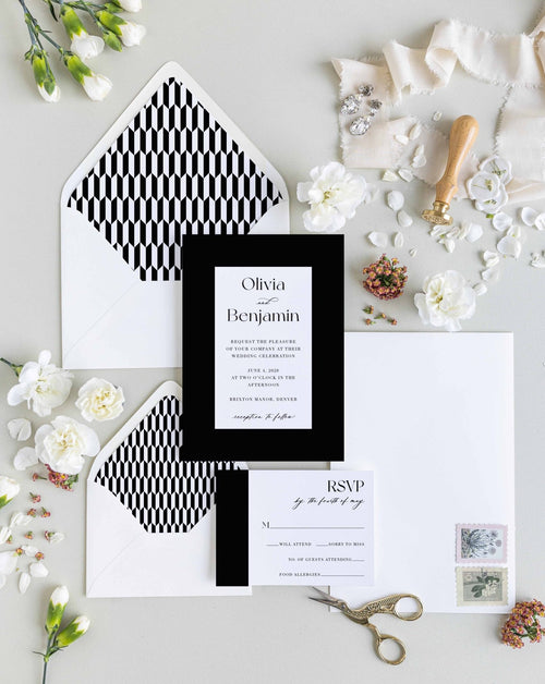 Bold Border wedding invitation suite by Blú Rose, invitation and RSVP card with a bold black border and script names, styled with geometric-lined envelopes, ribbon, and a wax seal