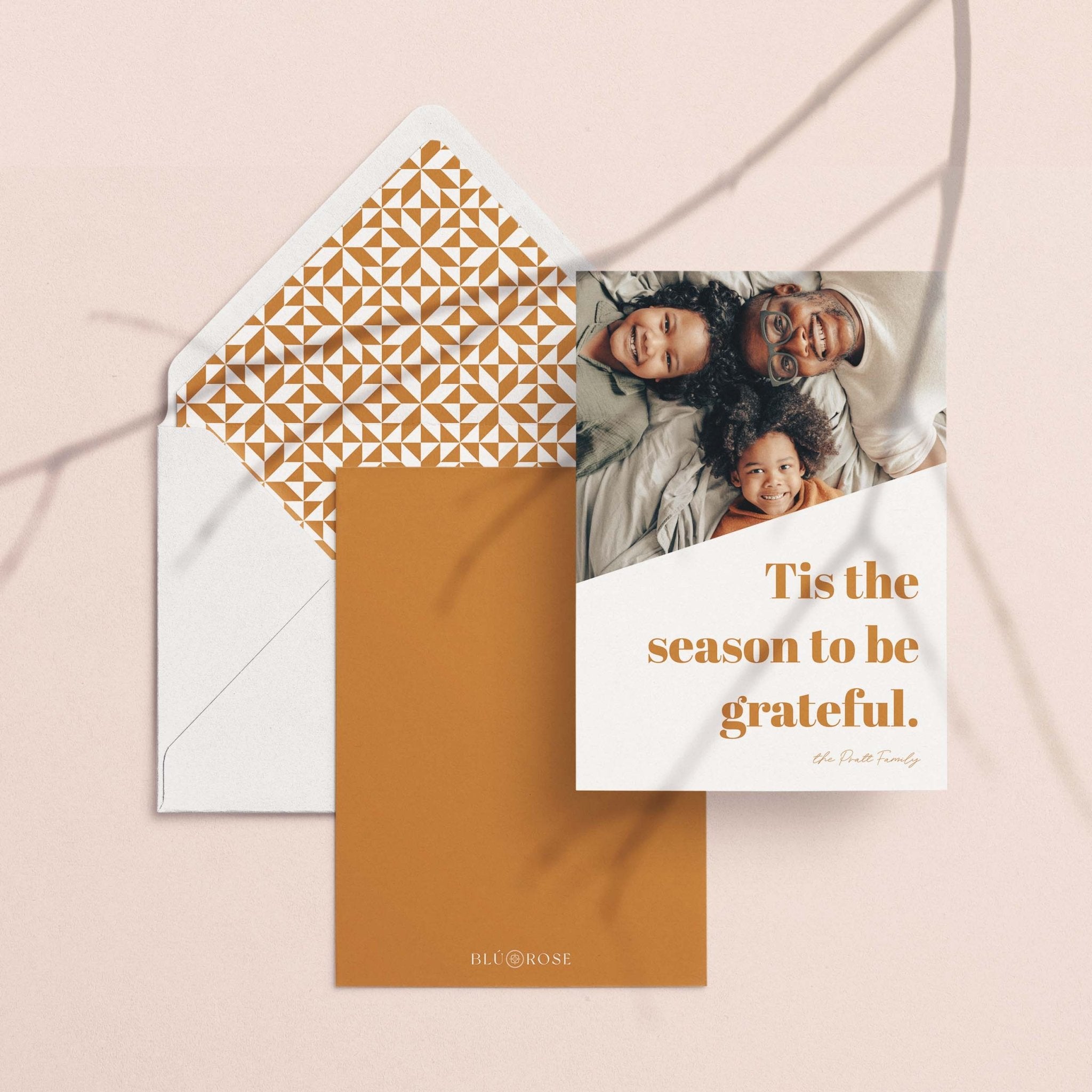Bold Letters card with its golden lattice envelope liner styled on a blush backdrop