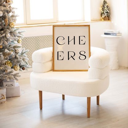 Neutral “CHEERS” art print displayed on a chair in a bright living space with holiday decor.