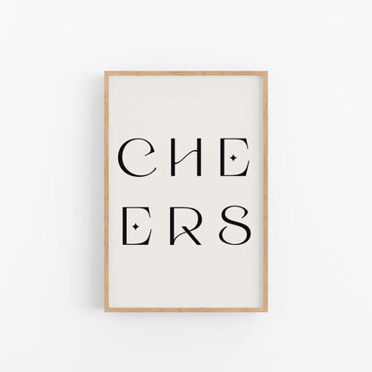Minimal “CHEERS” typography art print with black lettering in a wood frame on white wall.