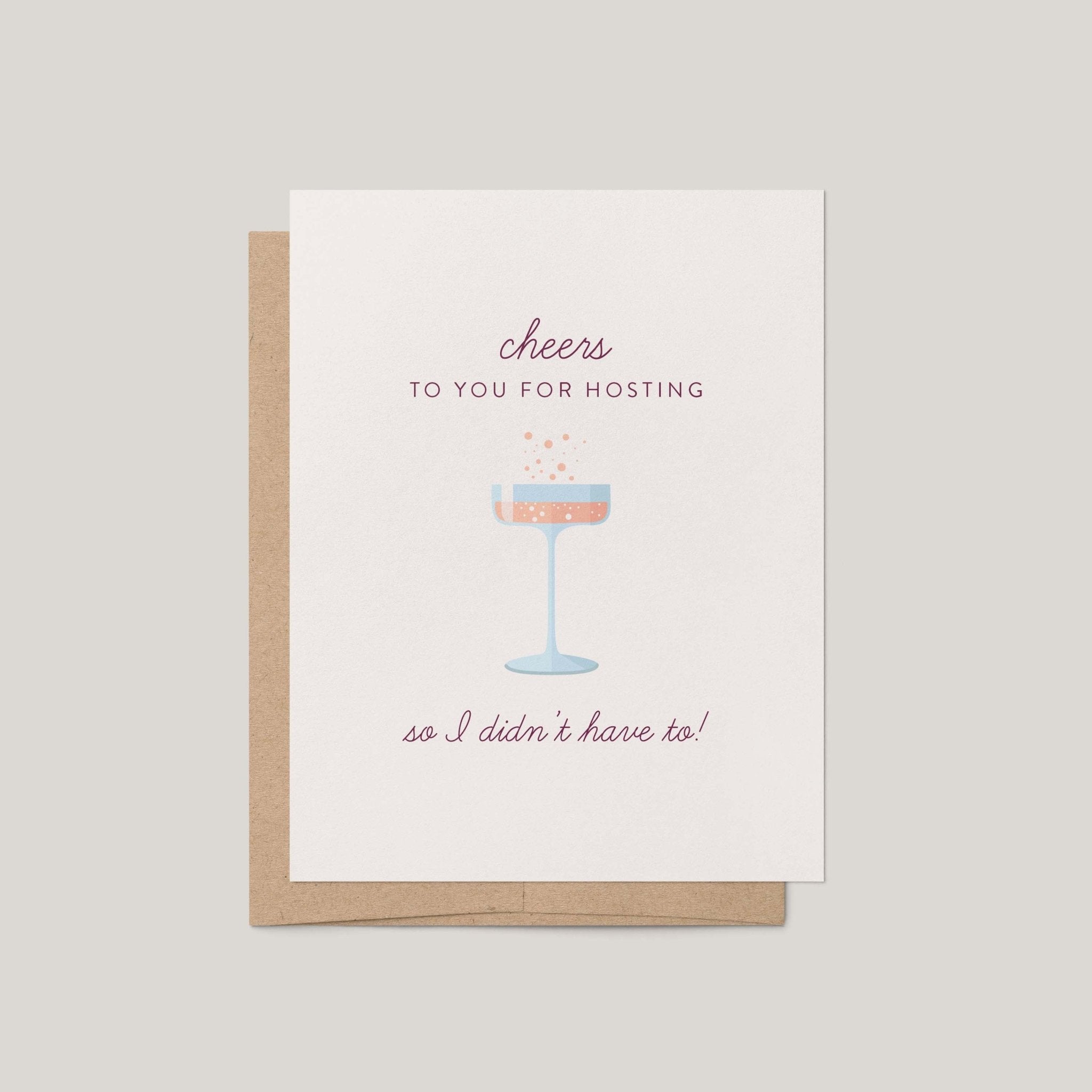 Cheers to Hosting greeting card by Blú Rose, ivory card with mauve script and champagne coupe illustration, shown with kraft envelope