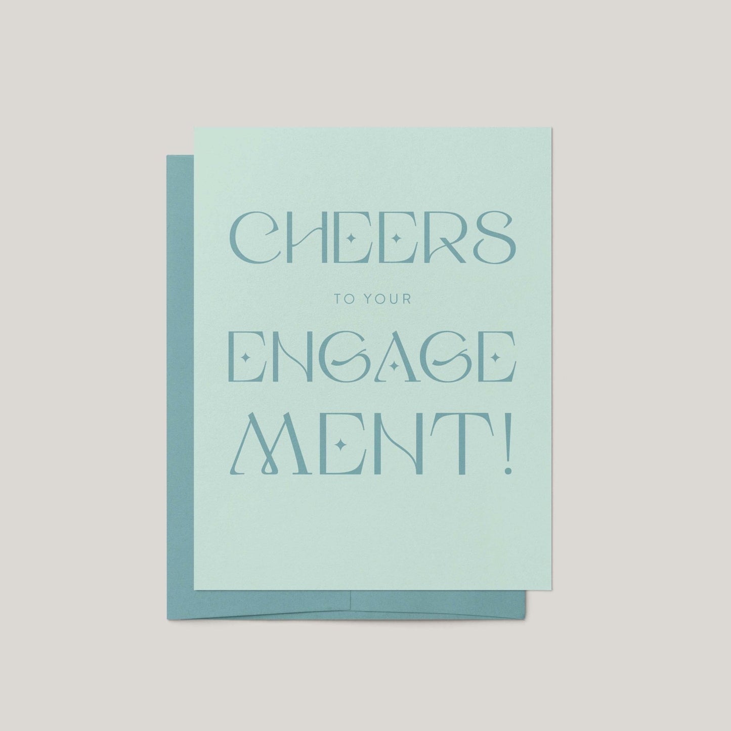 Card with 'Cheers to your engagement!' text on a light blue background
