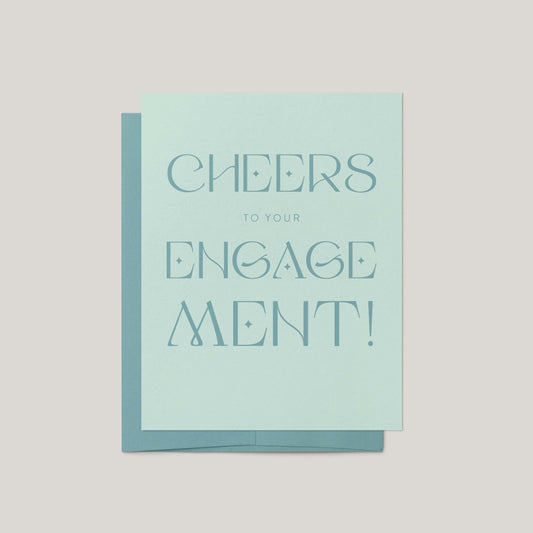 Card with 'Cheers to your engagement!' text on a light blue background