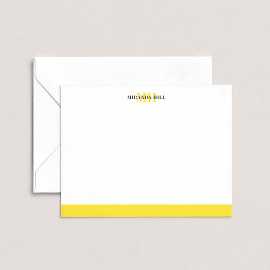 A white envelope with a yellow stripe and a blank card with the text "MIRANDA HILL" printed on it.