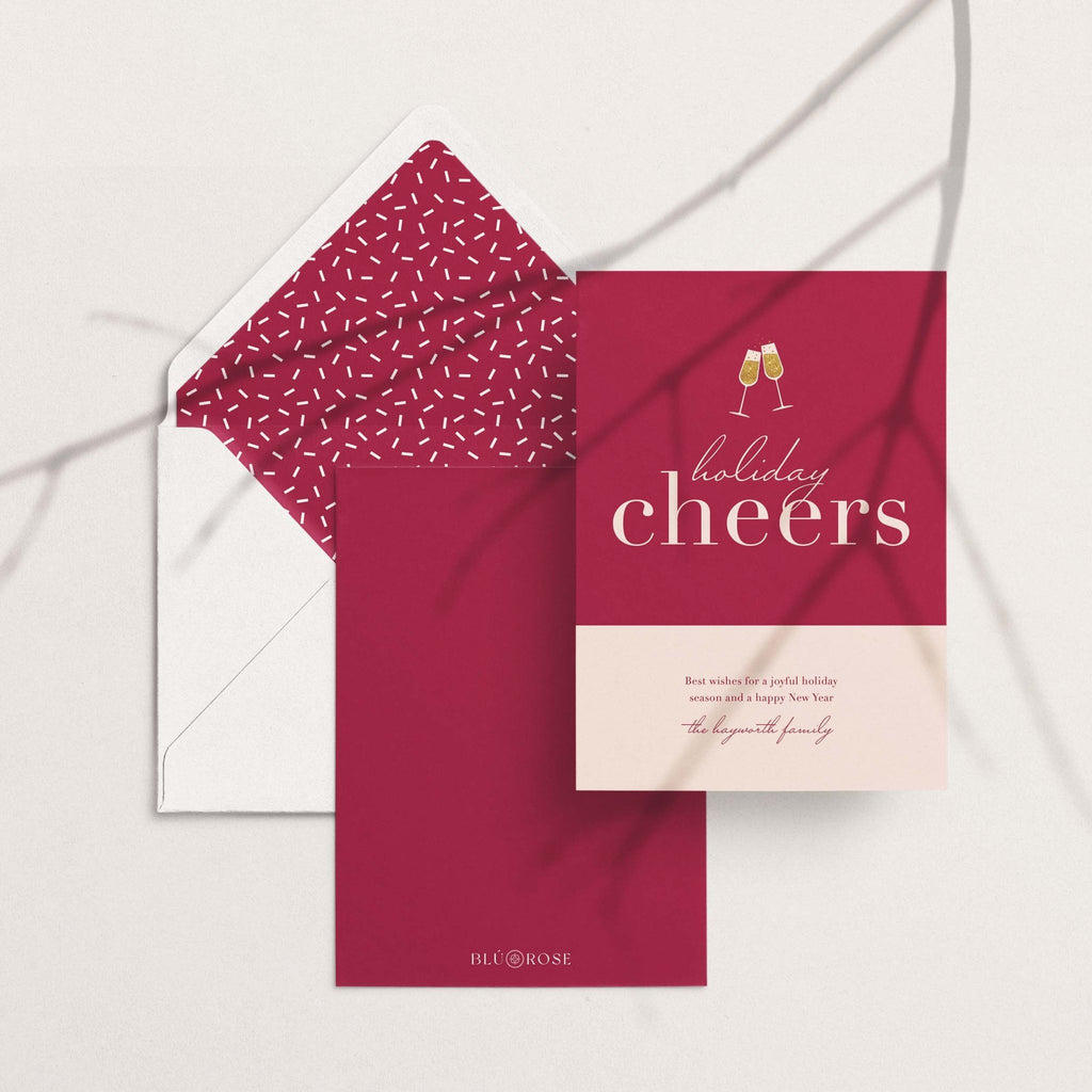 Color Block Cheers card with its burgundy speckled envelope liner styled on a blush backdrop