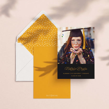 Confetti graduation announcement card styled with marigold patterned envelope liner on neutral background
