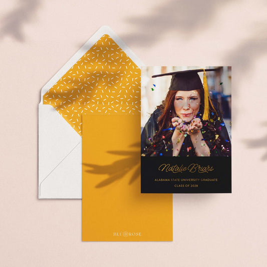 Confetti graduation announcement card styled with marigold patterned envelope liner on neutral background