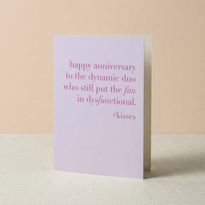 Greeting card with pink text on a beige background