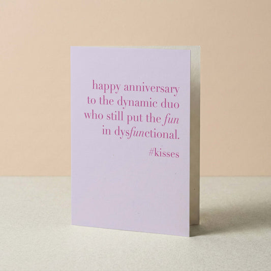 Greeting card with pink text on a beige background