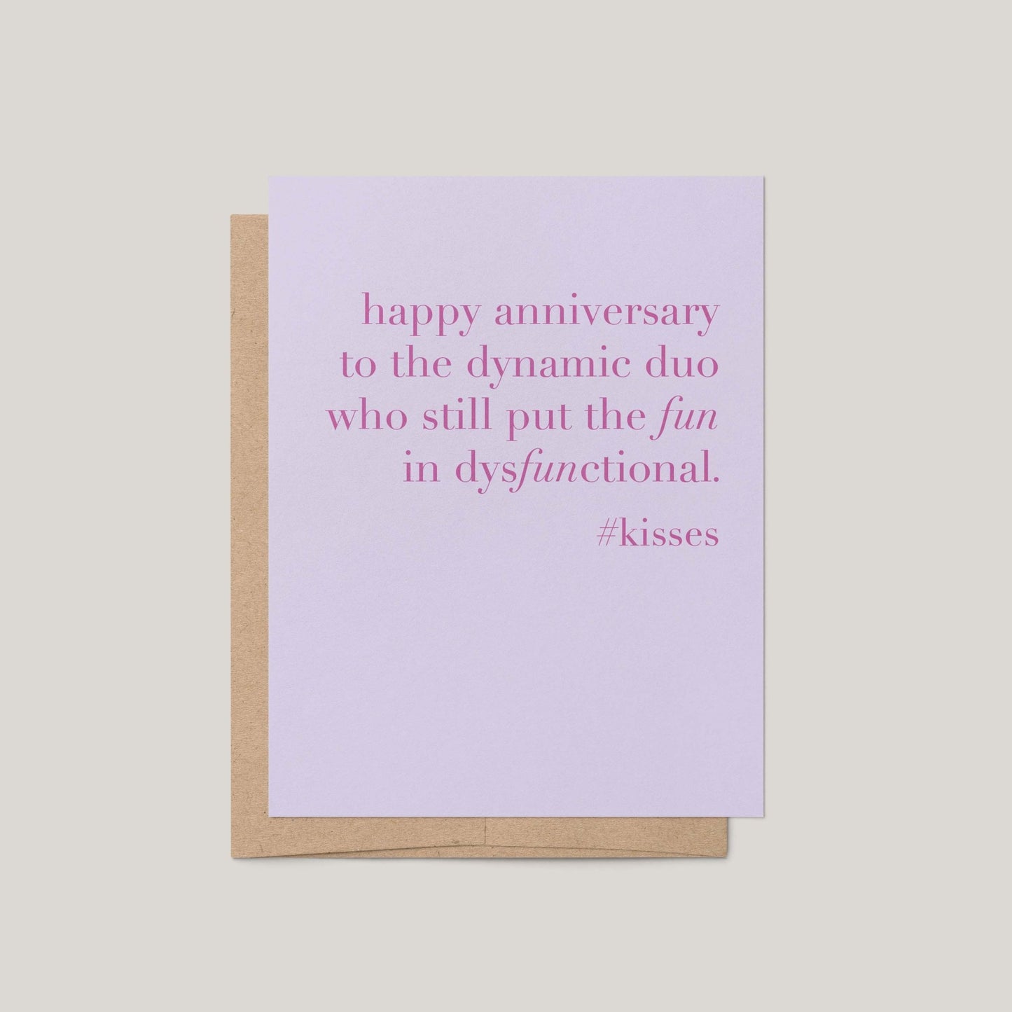 Card with pink text on a light purple background, placed on a beige surface.