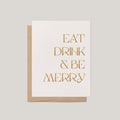 Eat, Drink & Be Merry holiday greeting card by Blú Rose, ivory card with gold glitter foil text, shown with kraft envelope