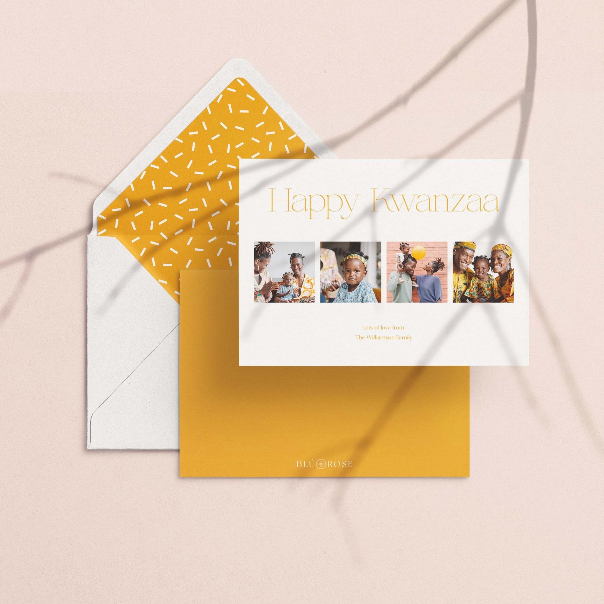 Elegant Four photo card with its golden confetti-print envelope liner on a blush backdrop