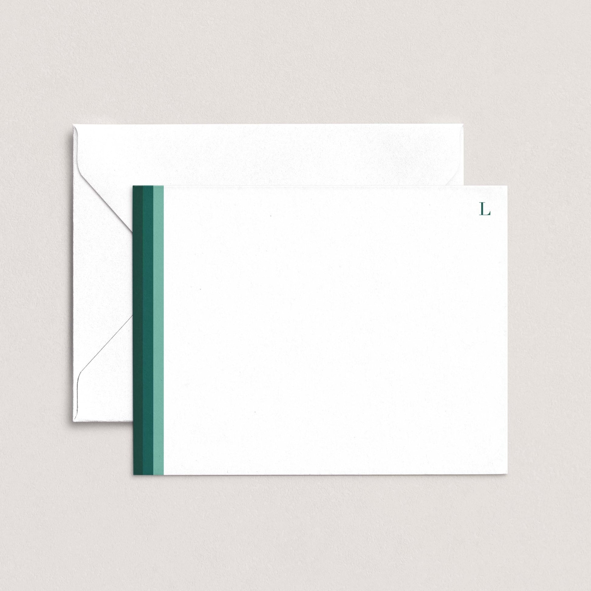 a white envelope with a green stripe on the left side, placed on top of a plain white background.