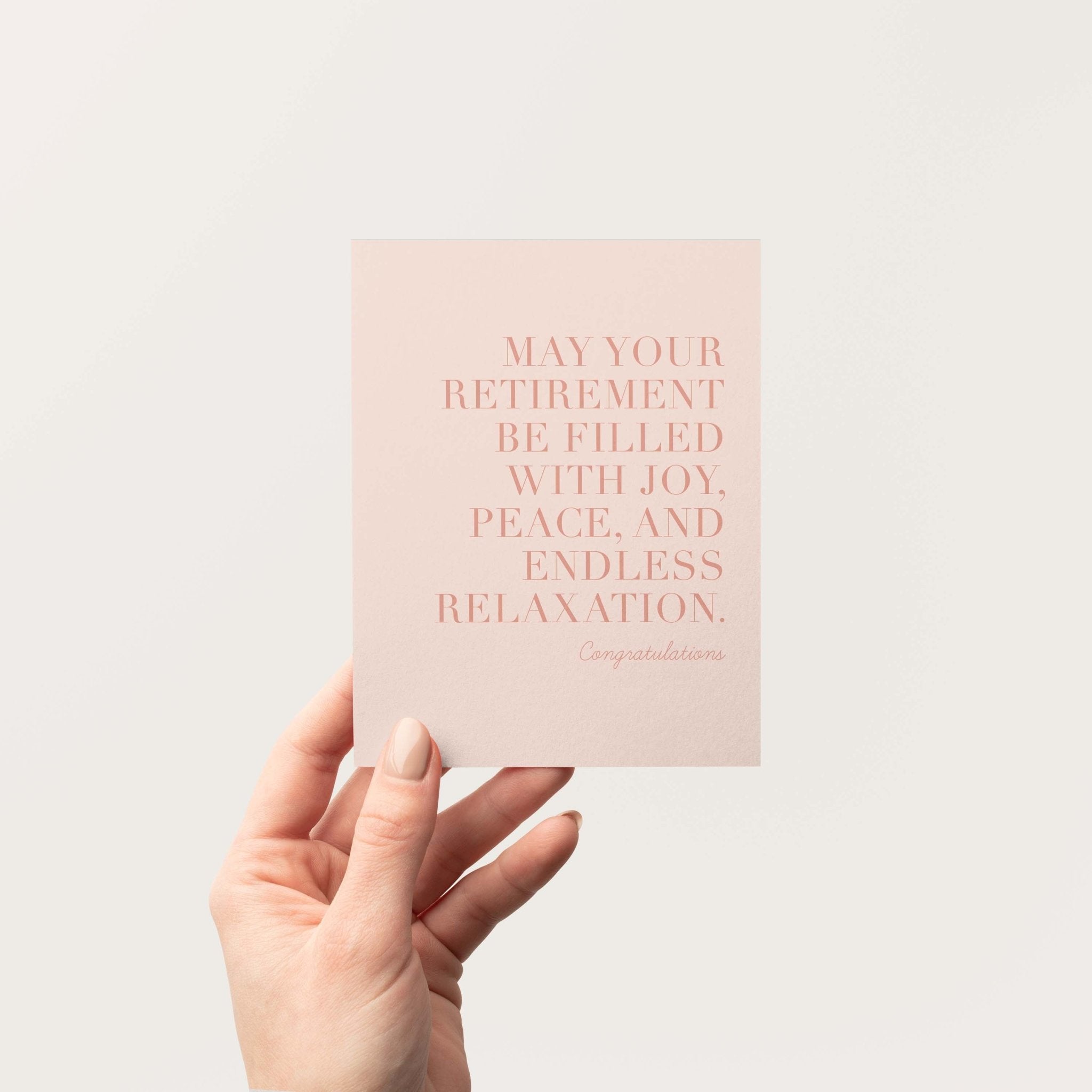 Endless Relaxation retirement greeting card by Blú Rose held in hand against a neutral off-white background
